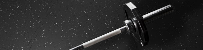 A barbell resting on GenaFlex recycled rubber flooring