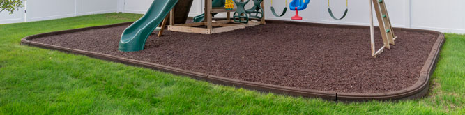 A playground with Playsafer Rubber Curb installed around it