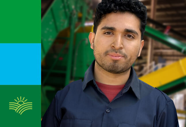 An LTR employee standing in front of machinery