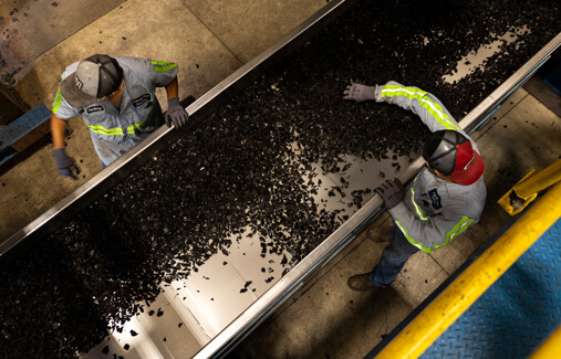 An aerial view of LTR employees sorting shredded rubber