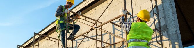Construction workers building scaffolding